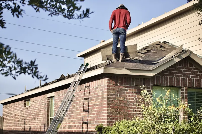 Professional roofer working on a residential roof in Vernon